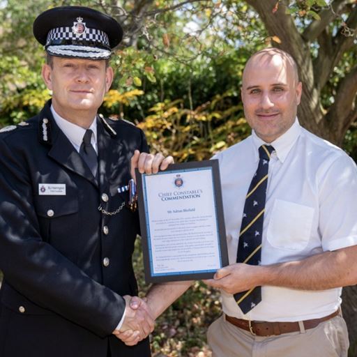Adrian Blofield receiving his award from the Chief Constable.