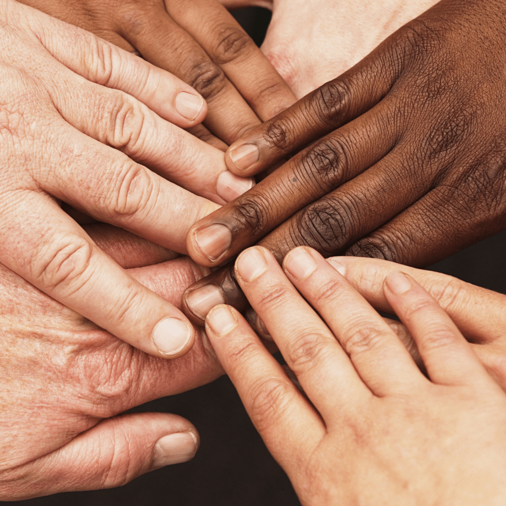 6 different coloured hands, one on top of another