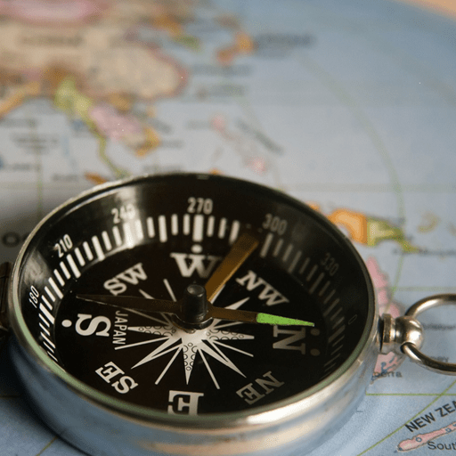 image of a compass on top of a map of the southern hemisphere