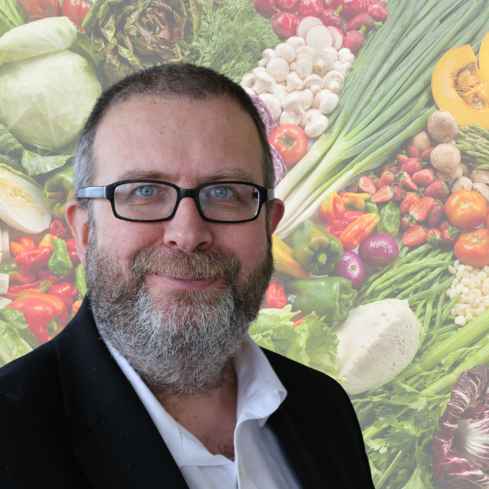 Headshot of Professor John Preston with a backdrop of vegetables