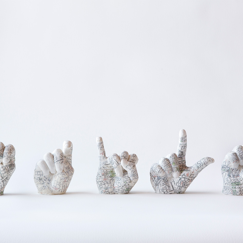 Lucid-Borders Artists Talk, Daniel Greenfield's A IS FOR EXILE, four dismembered plaster hands with maps of UK locations painted on them.jpg