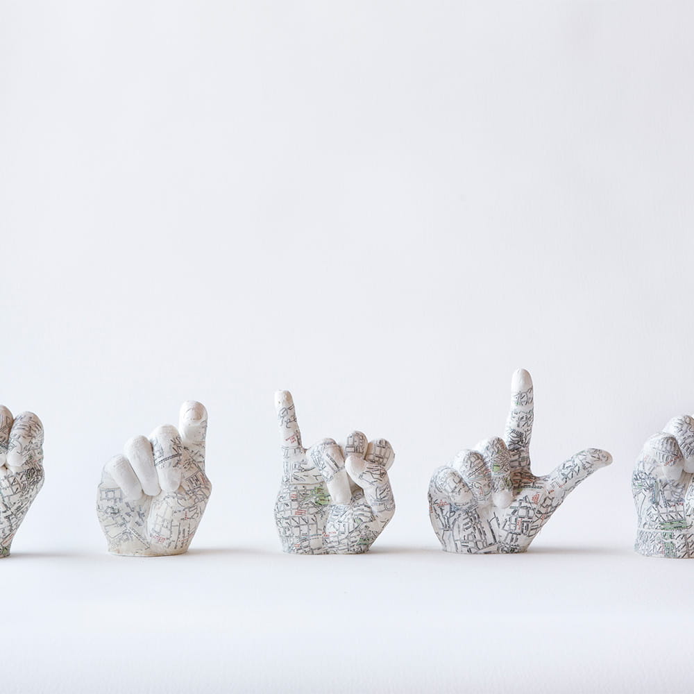 Lucid-Borders Artists Talk, Daniel Greenfield's A IS FOR EXILE, four dismembered plaster hands with maps of UK locations painted on them.jpg