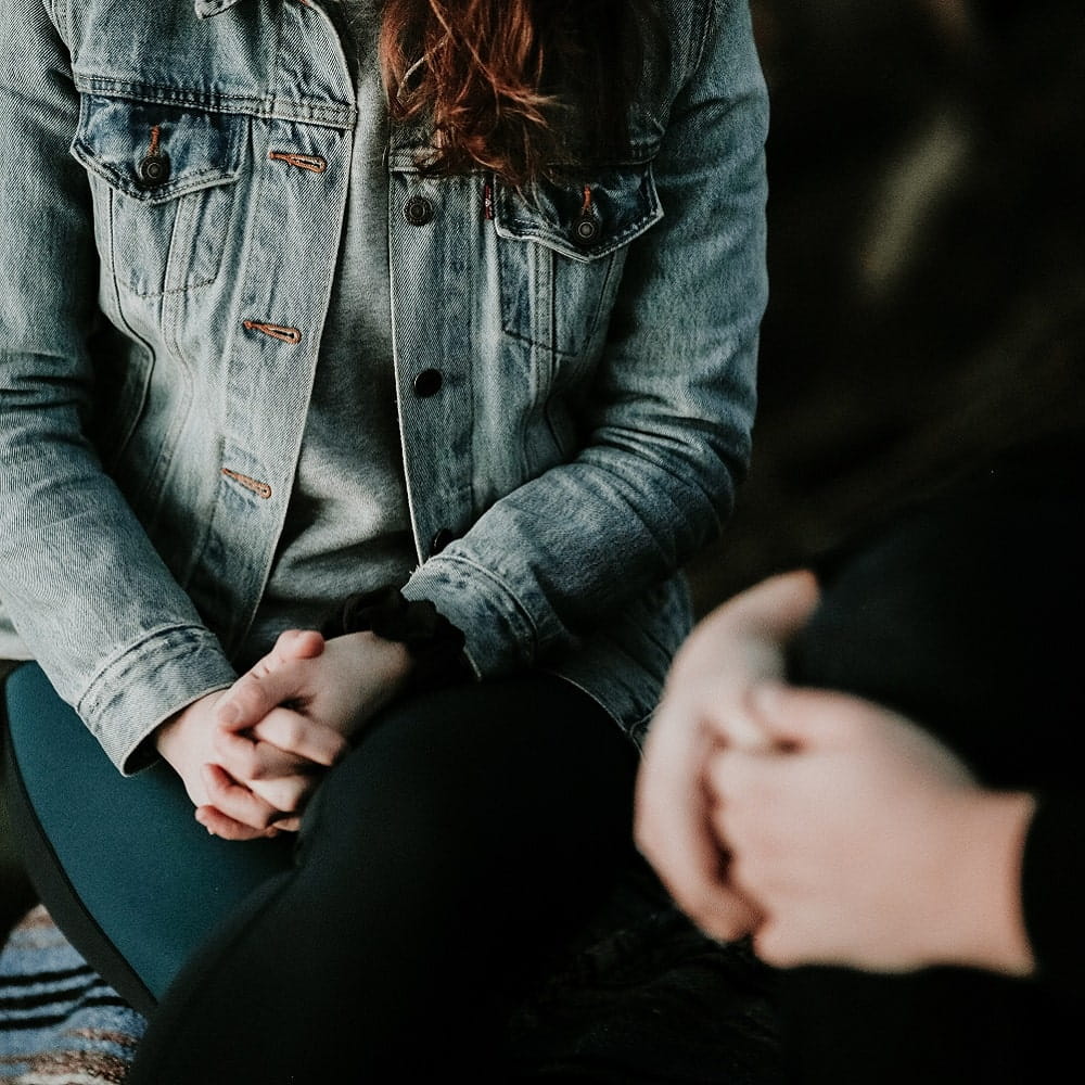 therapist and patient sat together, their faces are out of shot