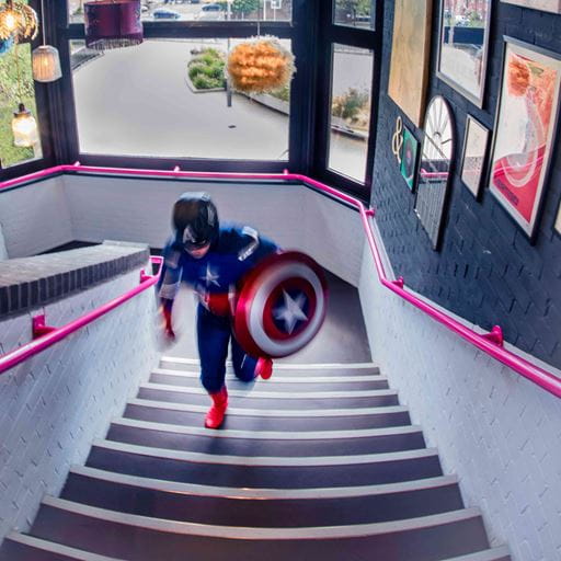 Man in superhero costume climbing stairs