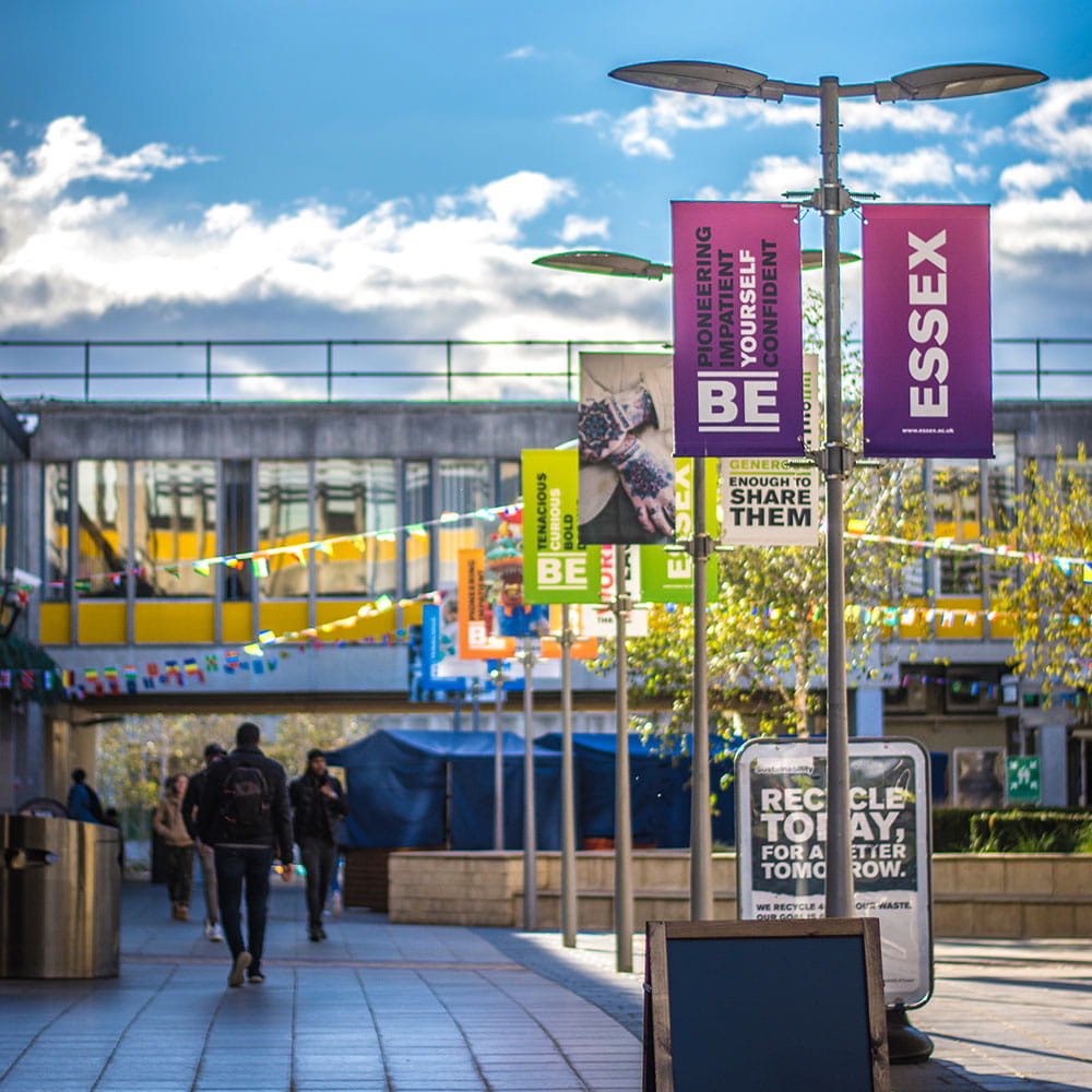Banners flying on a  sunny day on Colchester Campus Square 4.