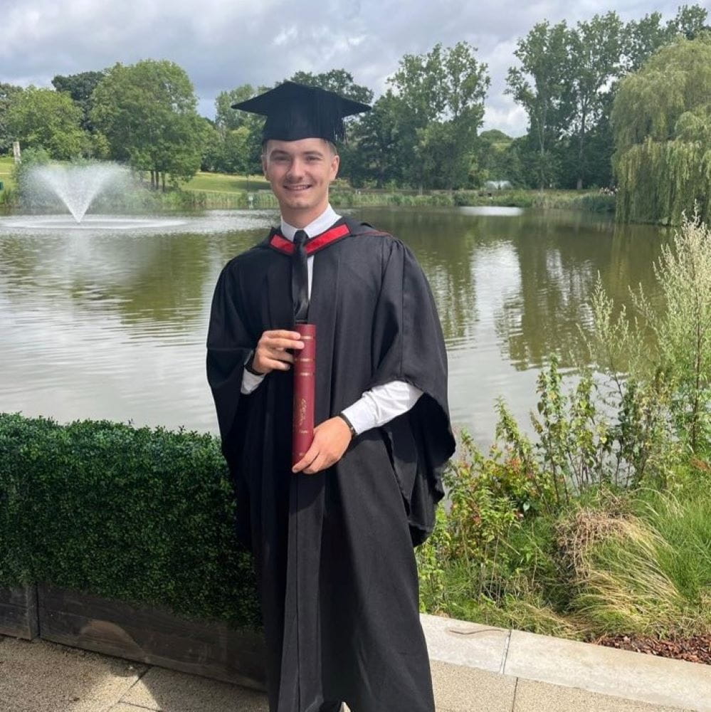 Image of EBS student George Kuderovitch in graduation cap and gown
