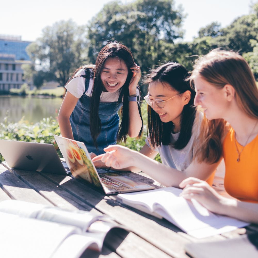 Students working beside lake