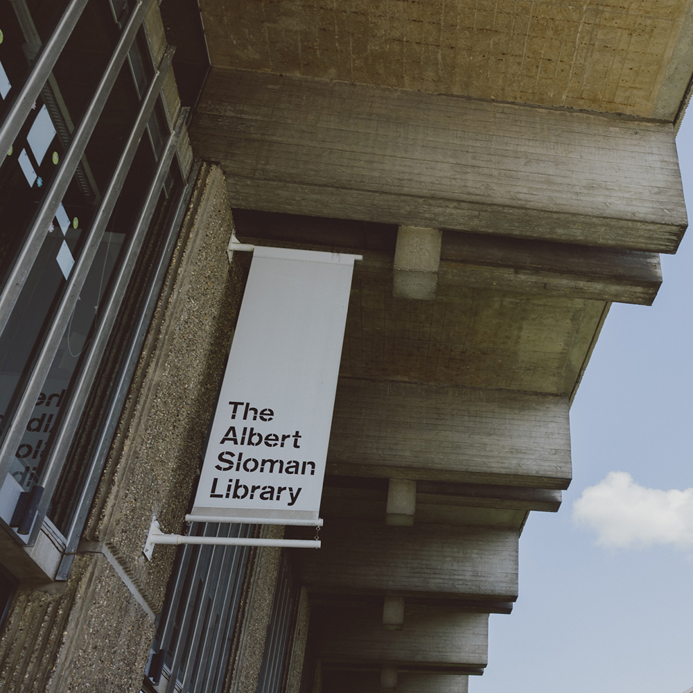Outside shot of the Albert Sloman Library looking up at the eaves and the concrete detail. There is also a hint of blue sky behind the impressive library building at the Colchester Campus of the University of Essex.