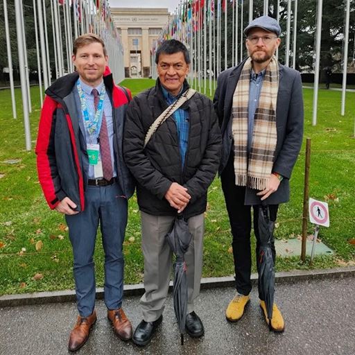 (left to right) Dr Matthew Gillett, Gabriel Muyuy Jacanamejoy, and Santiago del Hierro standing outside the UN in Geneva