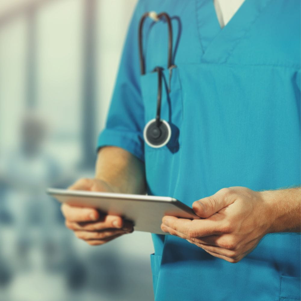 Generic photo of a doctor looking at notes inside a hospital