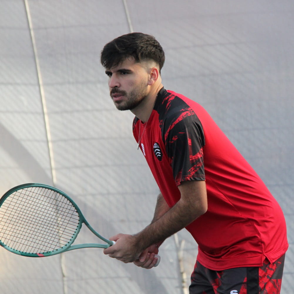 Carlos Corser Essex tennis team player holding raquet