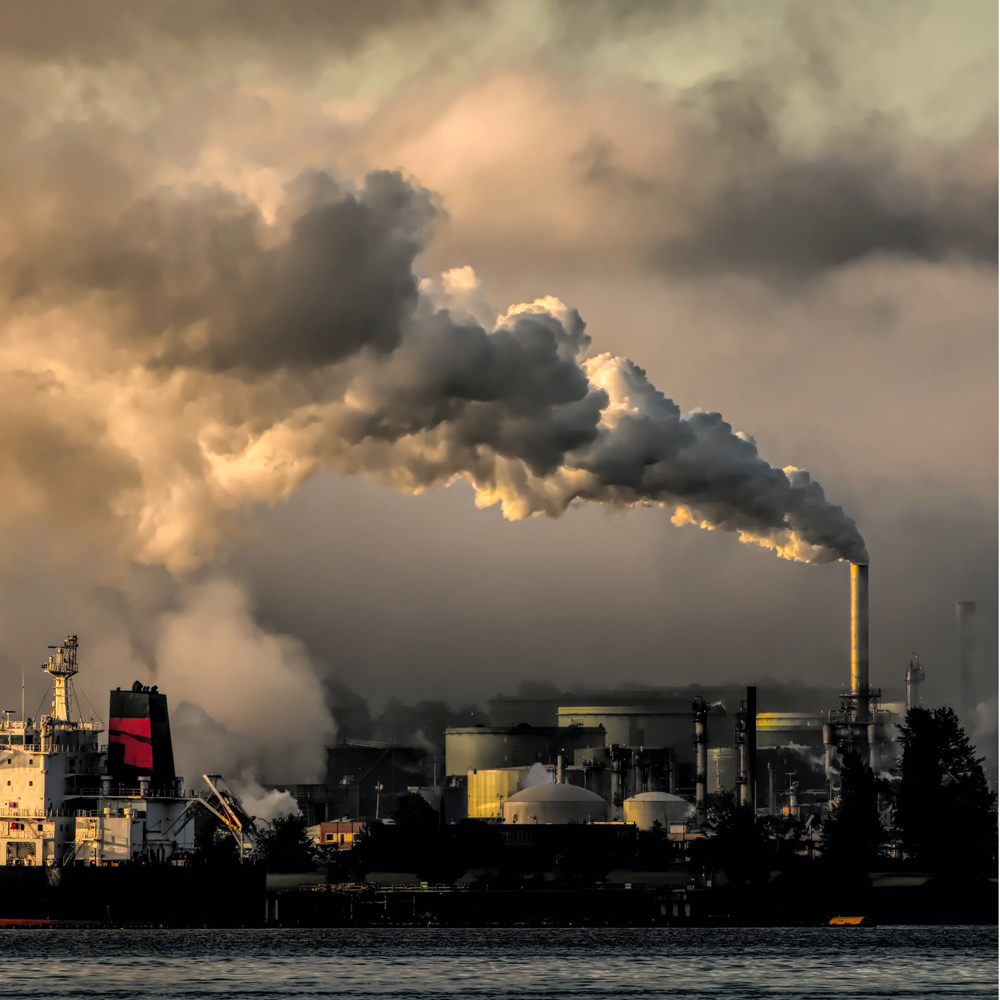 White smoke coming out of an industrial chimney