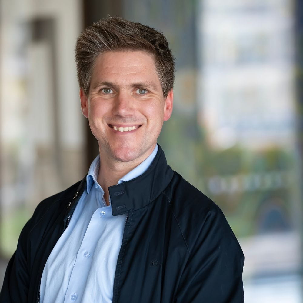 Dr Dennie Van Dolder, smiling