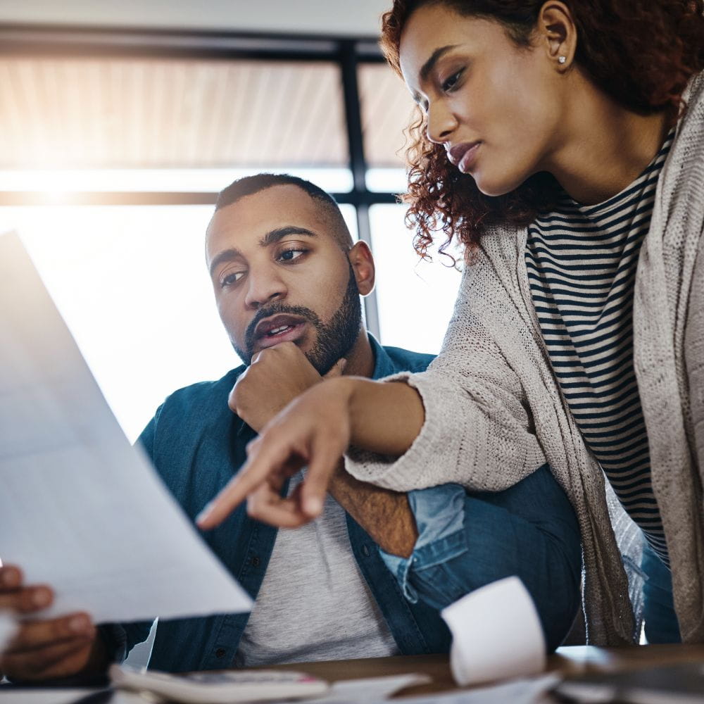 Couple discussing financial document