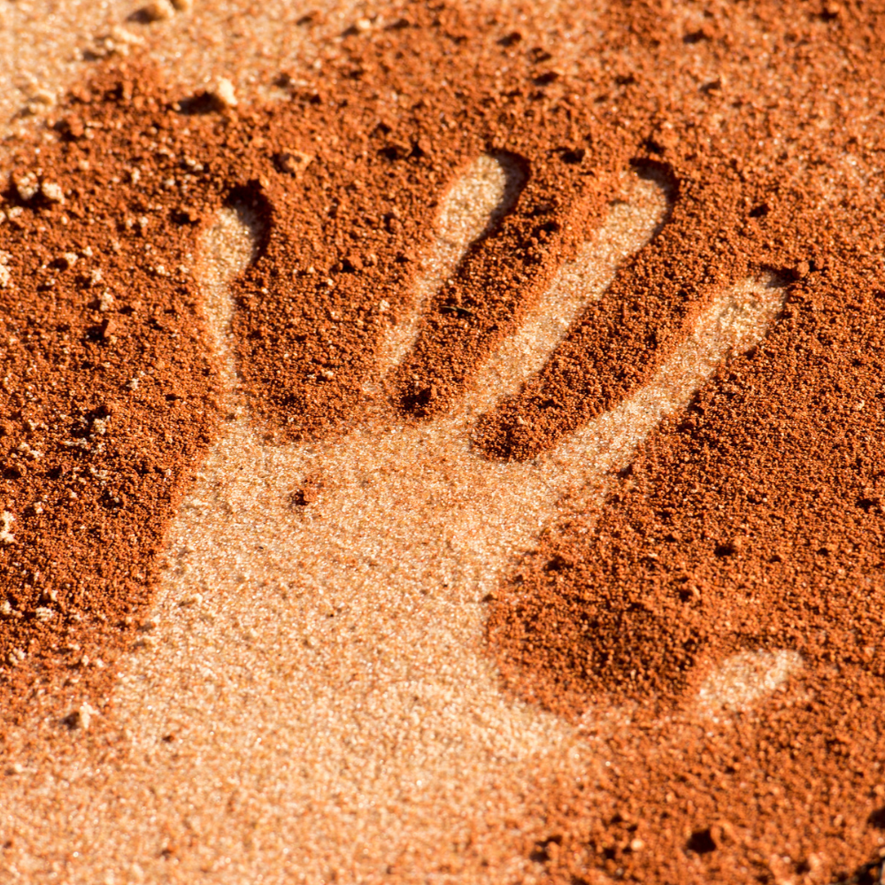 A hand print in sand