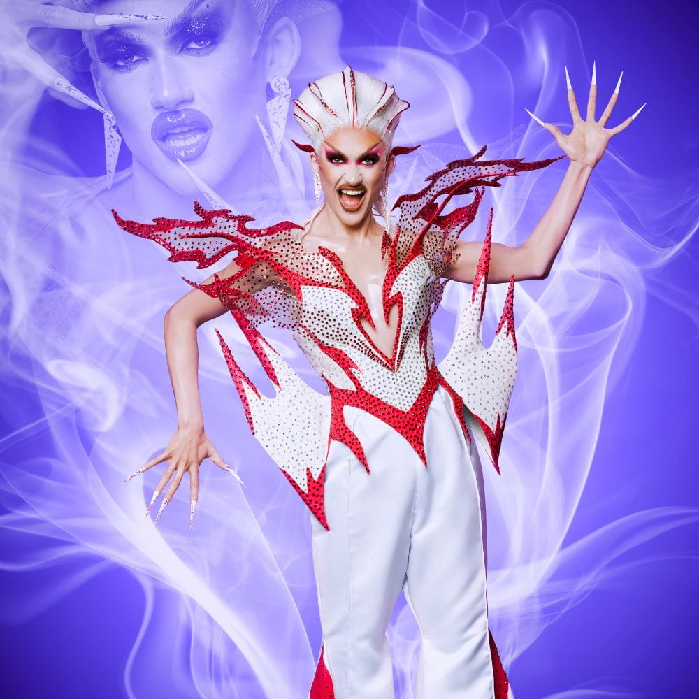 Drag queen Kyran Thrax snarls in flamboyant white and red costume