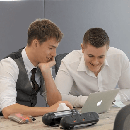 Two male students looking at laptop