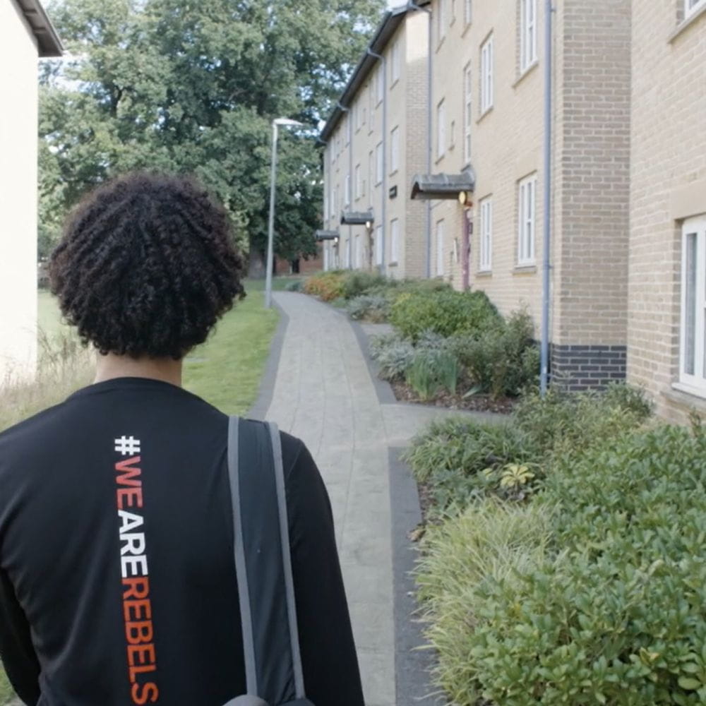 Student walking through Athlete Village 