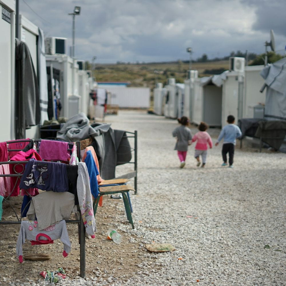 Children walking in migrant camp