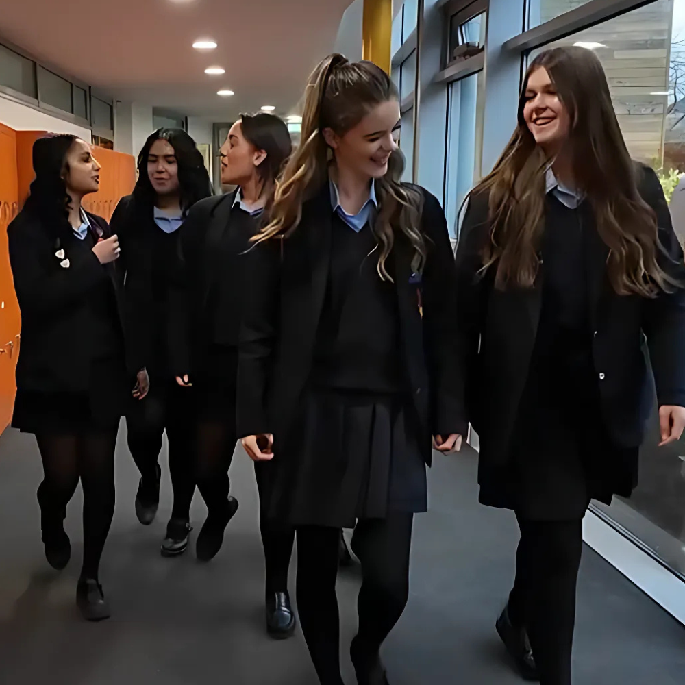 Students at Westcliff High School for Girls, walking in a corridor and talking