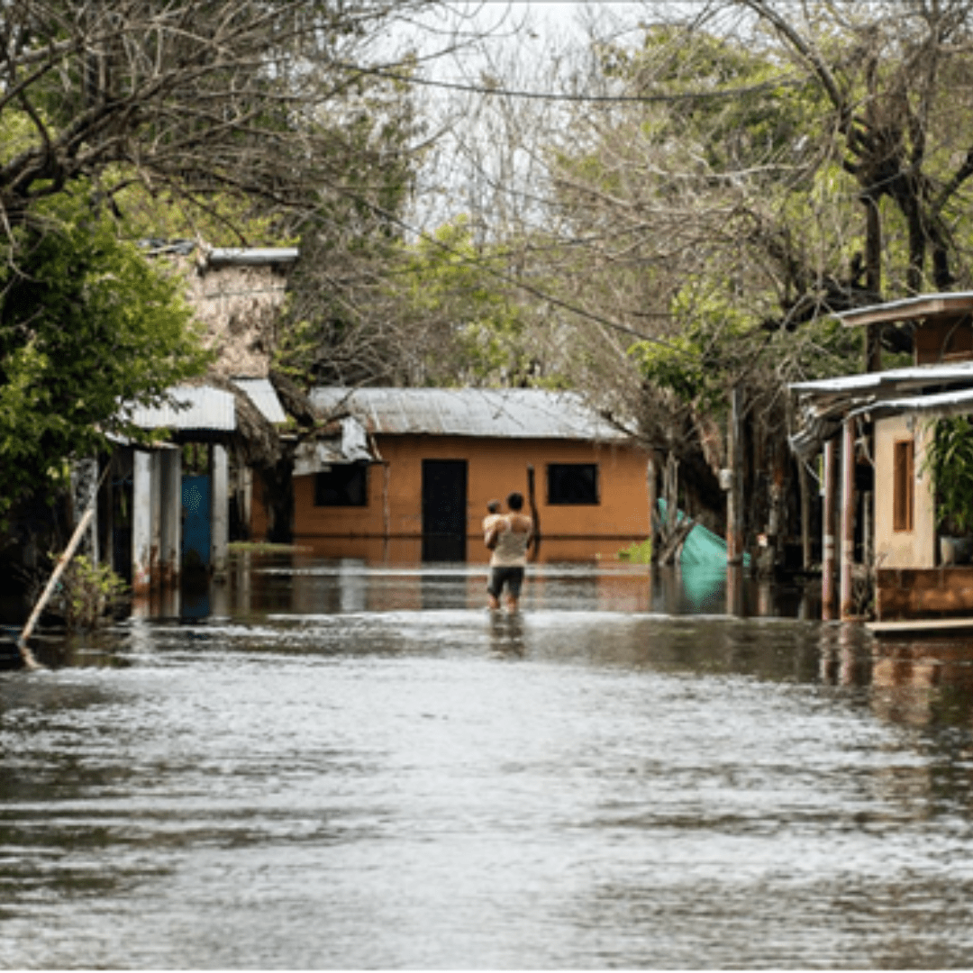 flooded village with boy walking