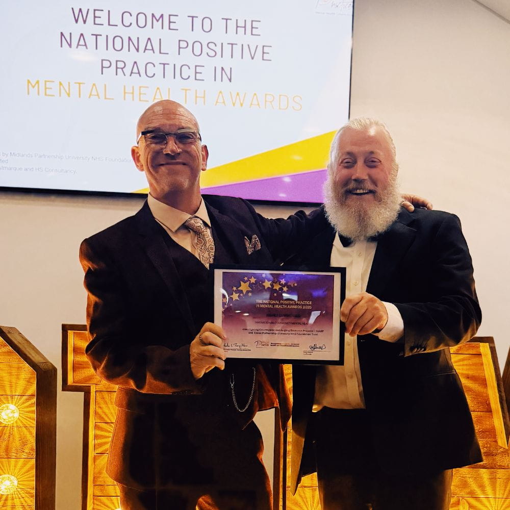 Dr Mark Wheeler and Dr Nick Cooper hold the certificate at the awards