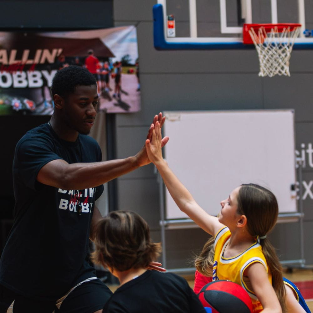 Essex Rebels ace Tyreese Hudson high fives children