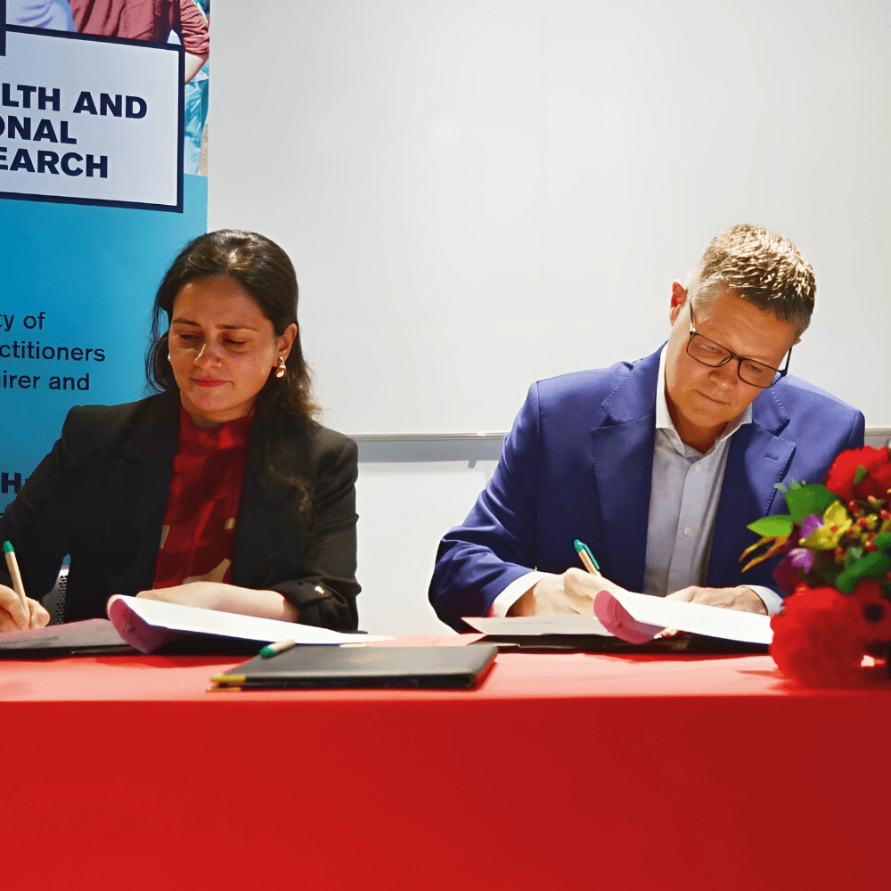 Professor Anuj Kapilashrami signing the MoU alongside TLMGB CEO Peter Waddup