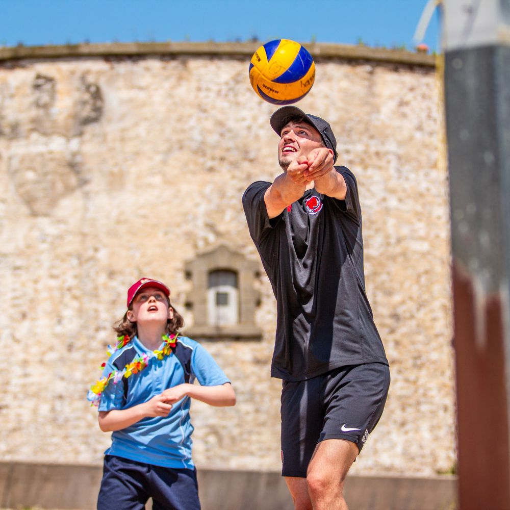 Euan Fraser demonstrates how to play to a young girl