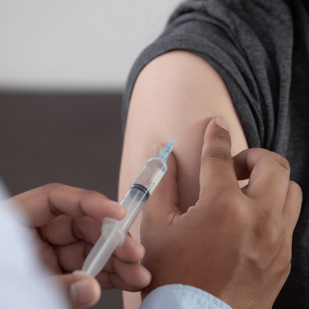 A vaccine being administered in a patient's arm