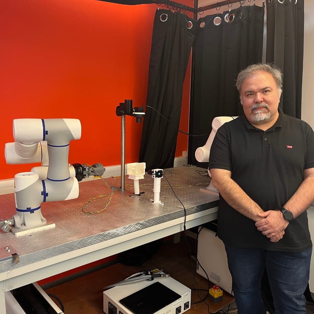 Dr Ali Hoshiar next to the TNE 