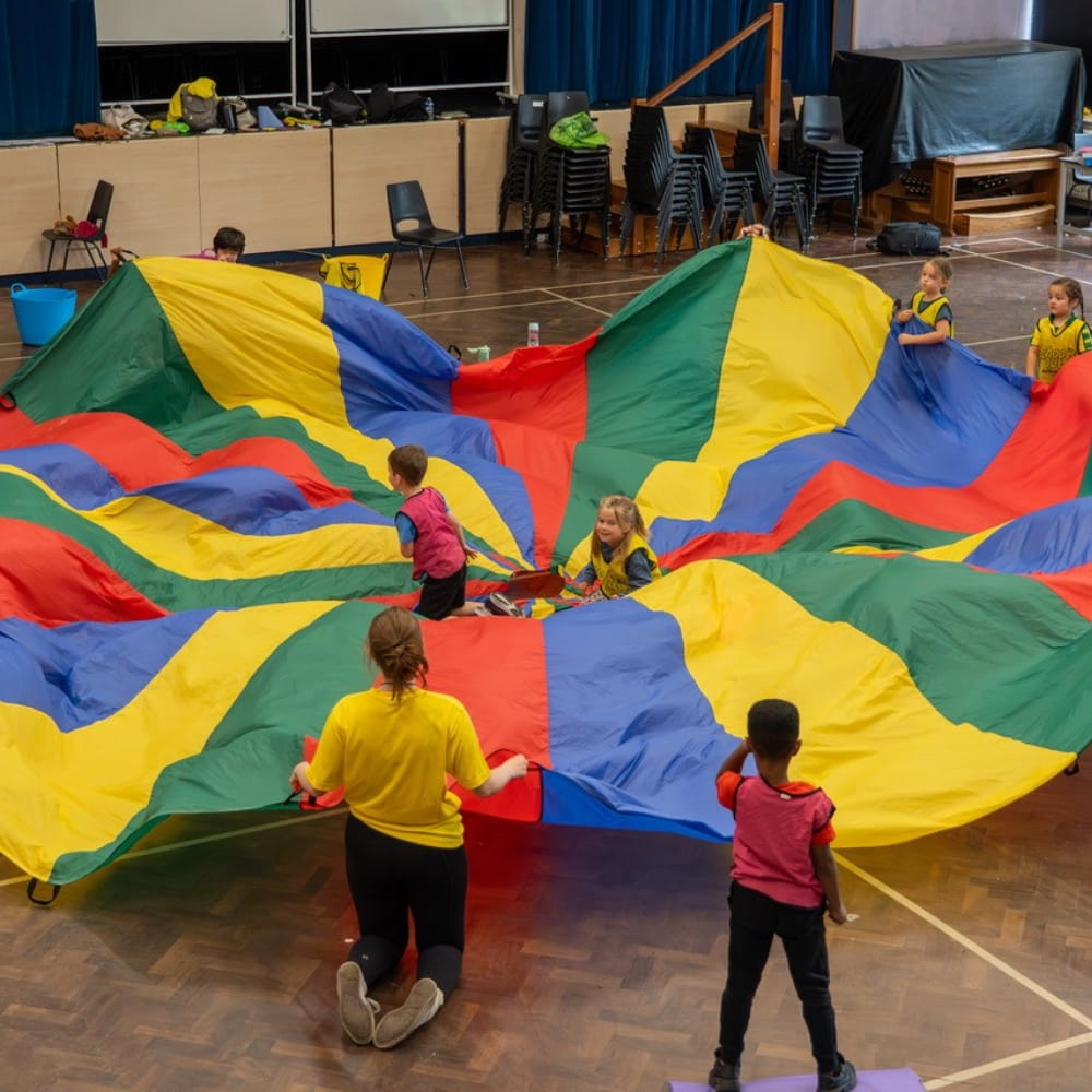 A Schools Out activity with a large, colourful blanket