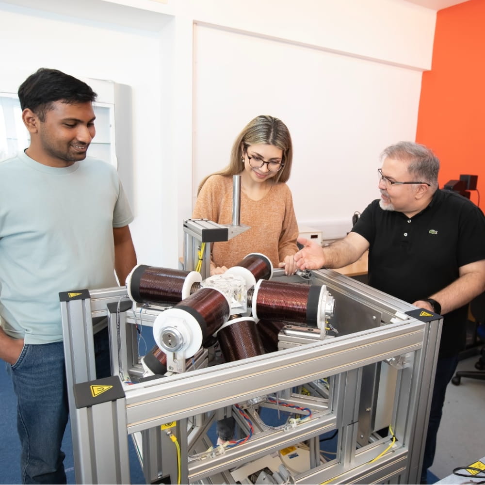 Dr Ali Hoshiar with the two students in the llab