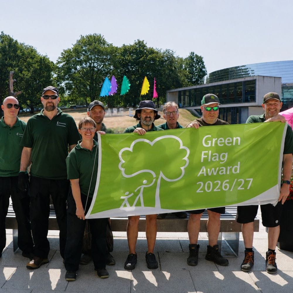 Our Grounds Team holding aloft the Green Flag award.