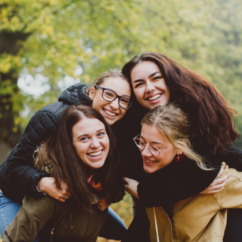 Happy students smiling together on campus