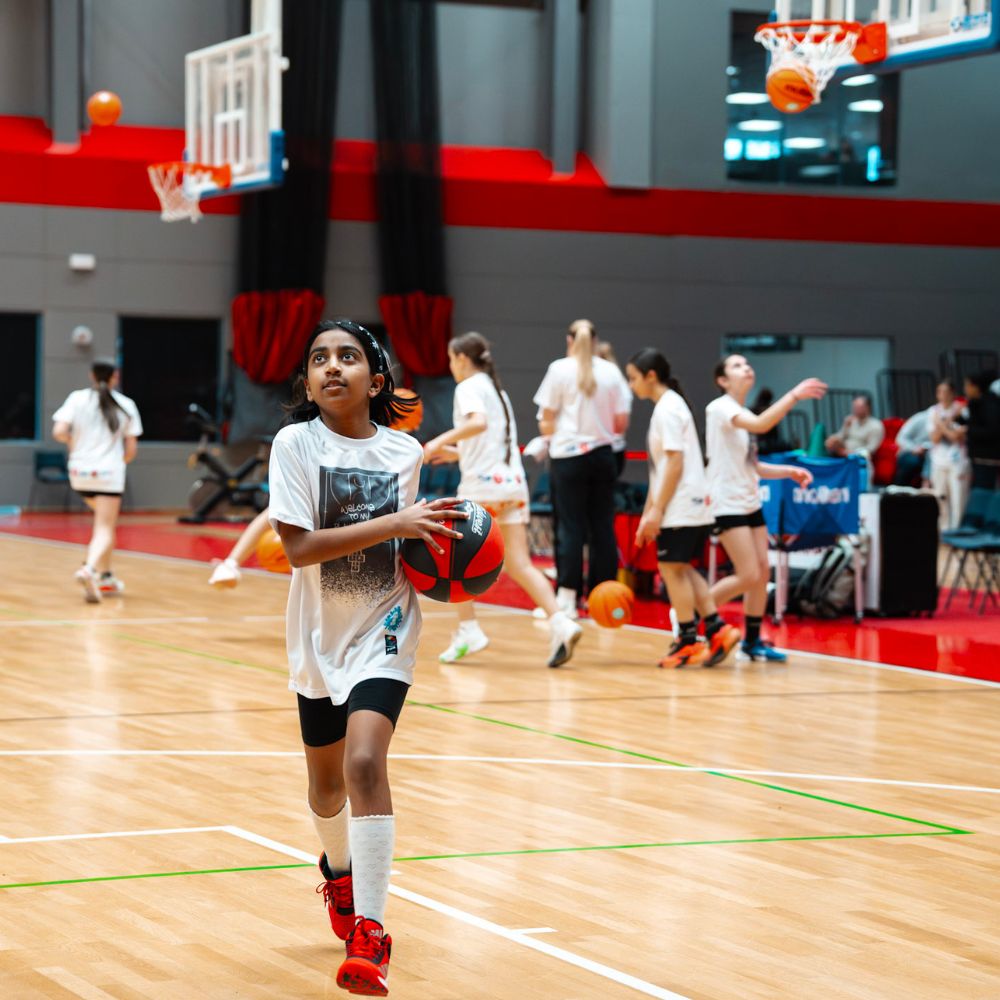 A young girl playing basketball