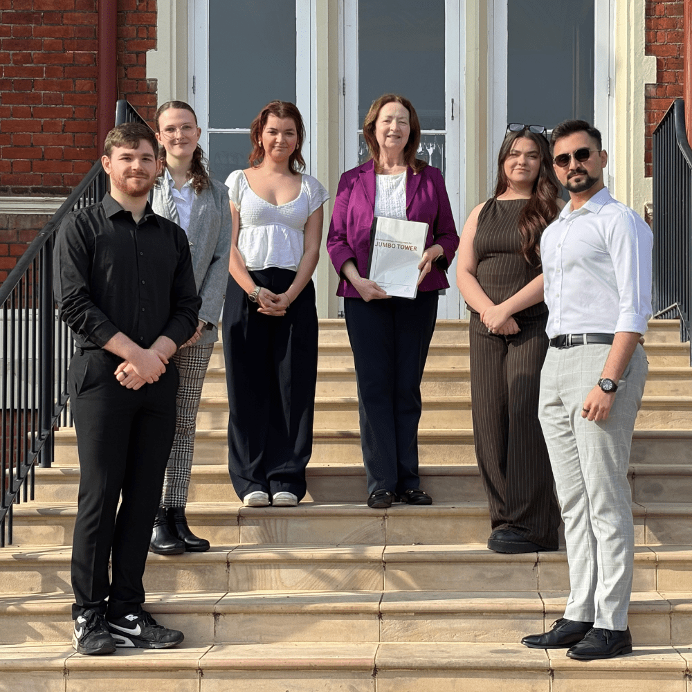 Students join Irene Kettle of the Jumbo Project on the steps of the Wivenhoe House Hotel
