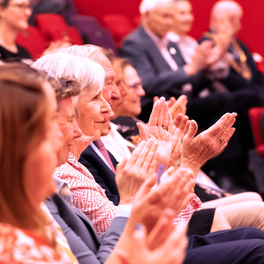 Members of Court and friends of the University applaud the Annual Meeting speech