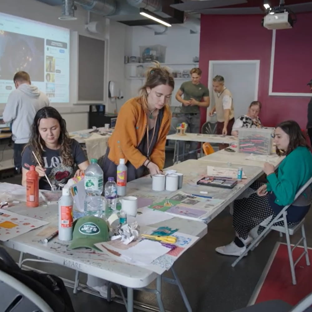 People playing with paints around a table