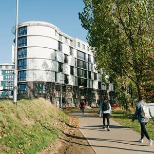 Students walking across campus through the accommodation
