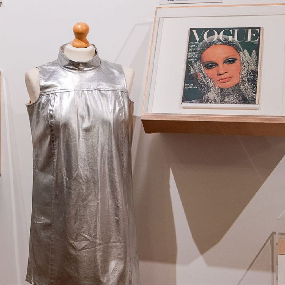 A space-age silver mini dress on a mannequin, next to a framed front cover of Vogue magazine - picture courtesy of Matt Savage