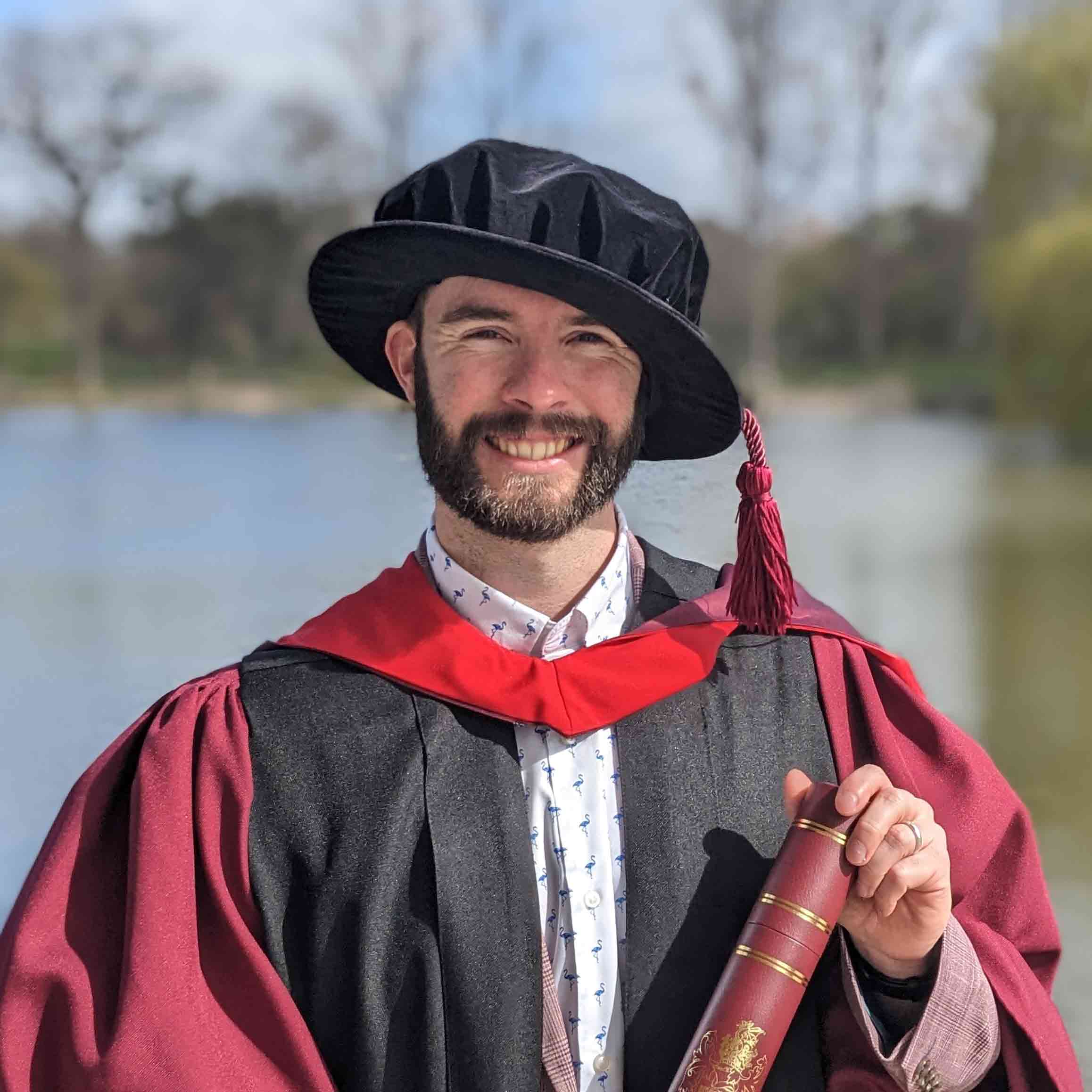 Joshua Fullard wearing academic cap and gown
