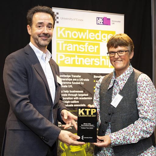 Professor Chris Greer handing KTP Best Academic award to Professor Tracy Lawson
