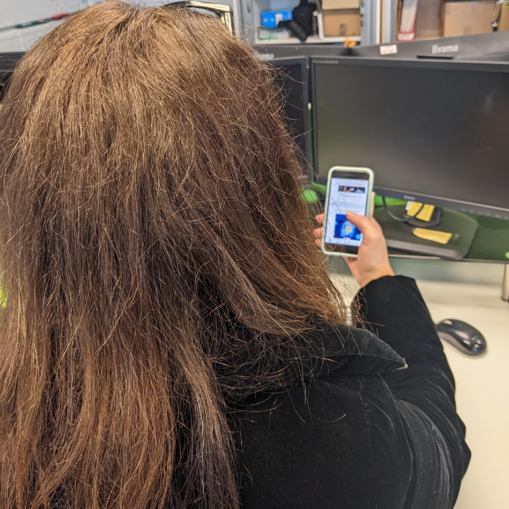 A woman looks at social media on her phone