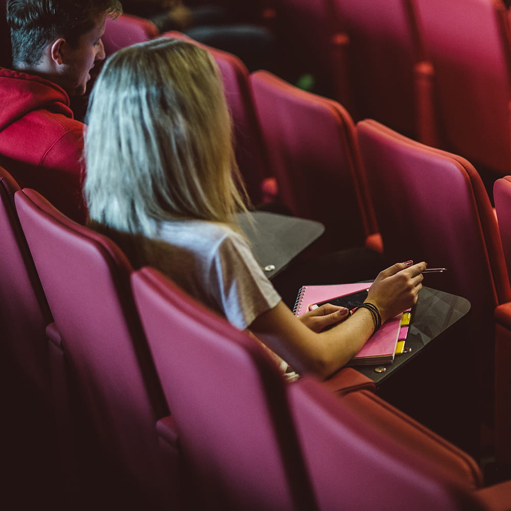 a girl sits in a seminar room