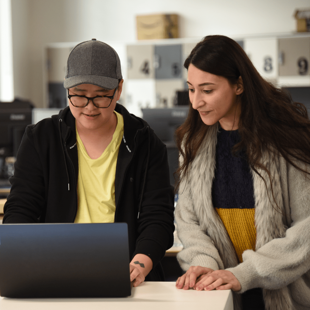 Two people looking at laptop
