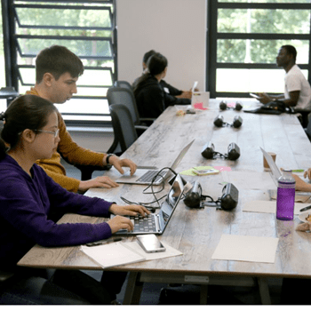 Students working on laptops in Studio X