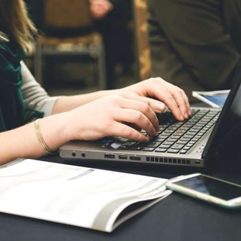 Woman typing on a laptop