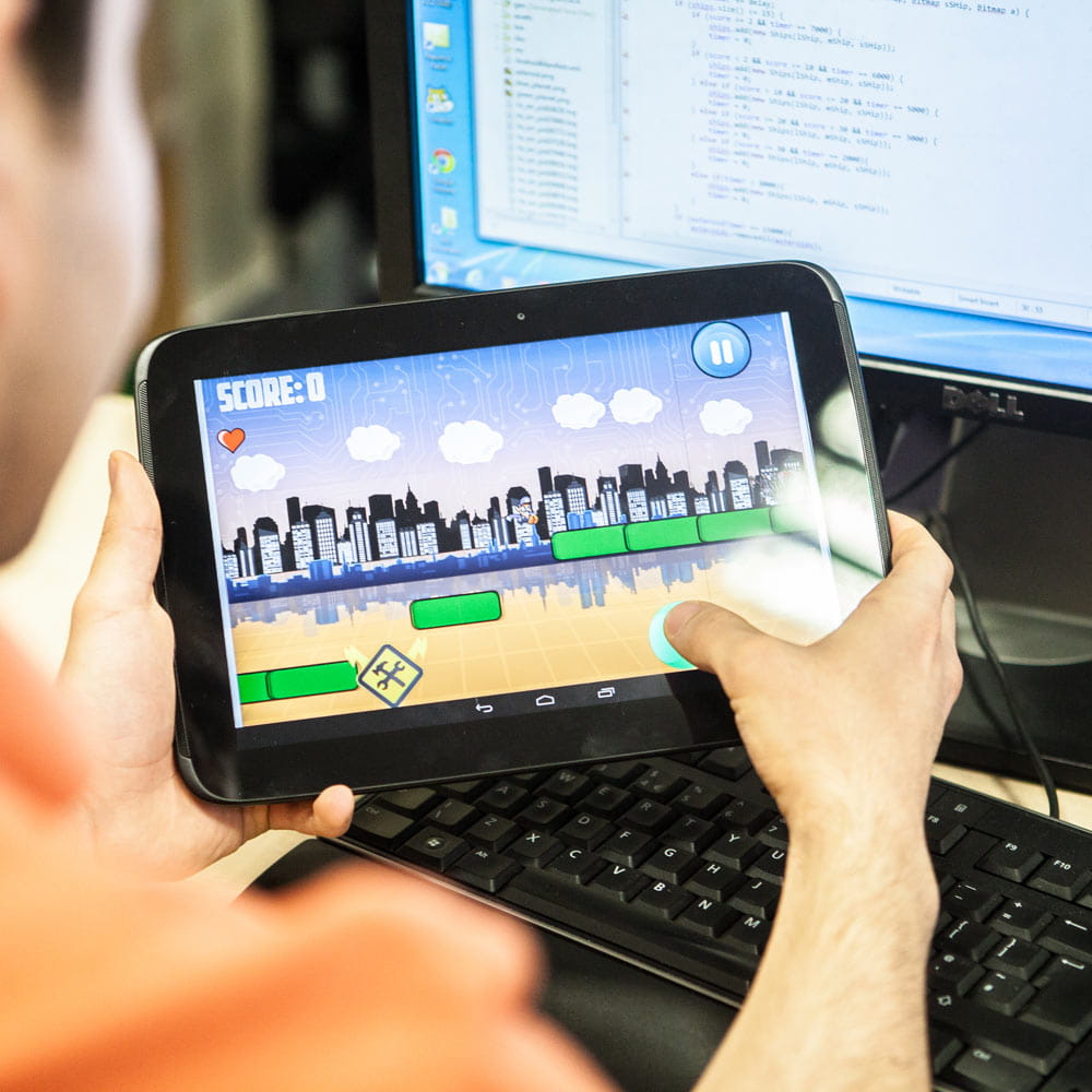 Person playing a game on a tablet device