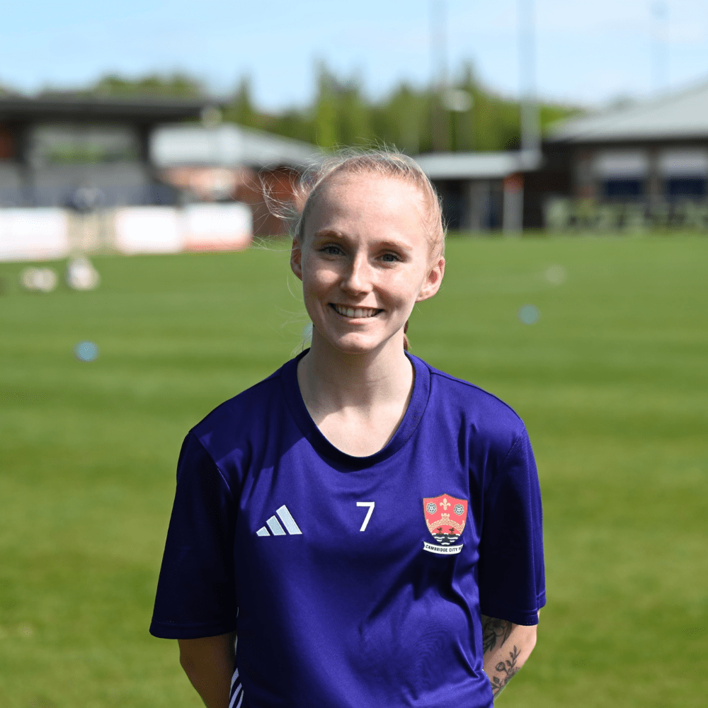 Shanie Marion, a young white woman with blonde hair wearing a sports shirt on a sports field.